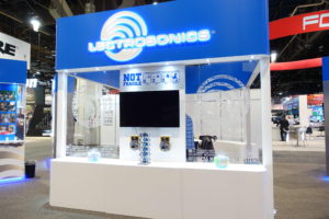 Exhibition booth with electronic display and signage.