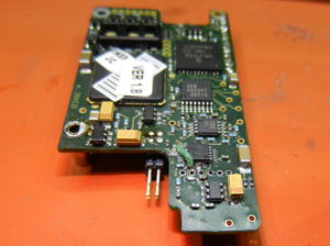 Electronic circuit board on orange background.