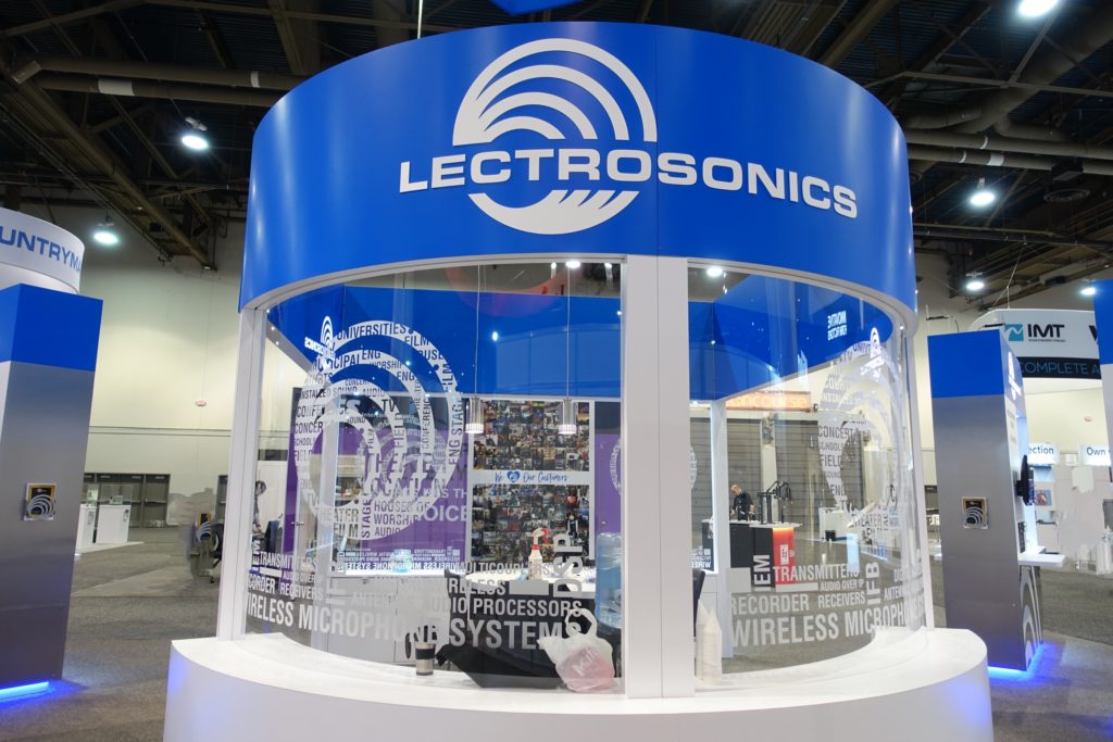 A blue and white booth with a large logo.