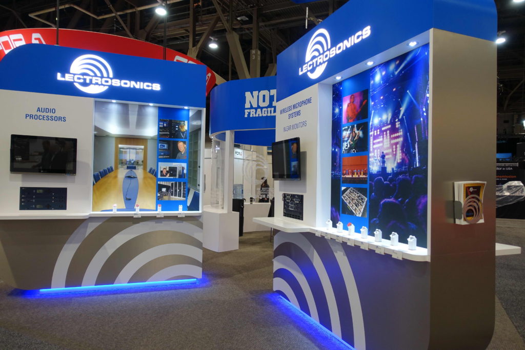 A booth with blue lighting and white walls.