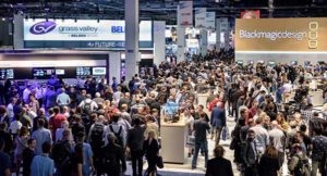 attend1-300x162-1 Crowded technology trade show with multiple booths.
